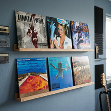 Houten planken met albumhoezen van Limp Bizkit, Blink-182, Red Hot Chili Peppers, Nirvana en System of a Down.